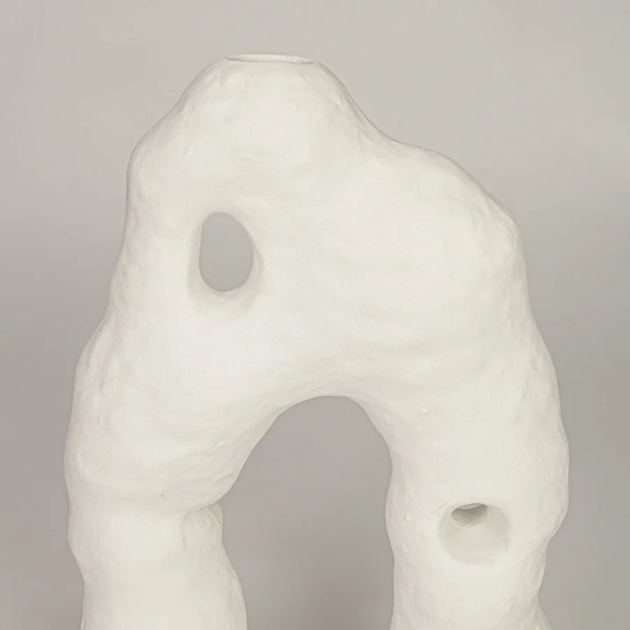 Closeup of white ceramic abstract sculpture with organic texture showcasing premium craftsmanship and artistic styling.