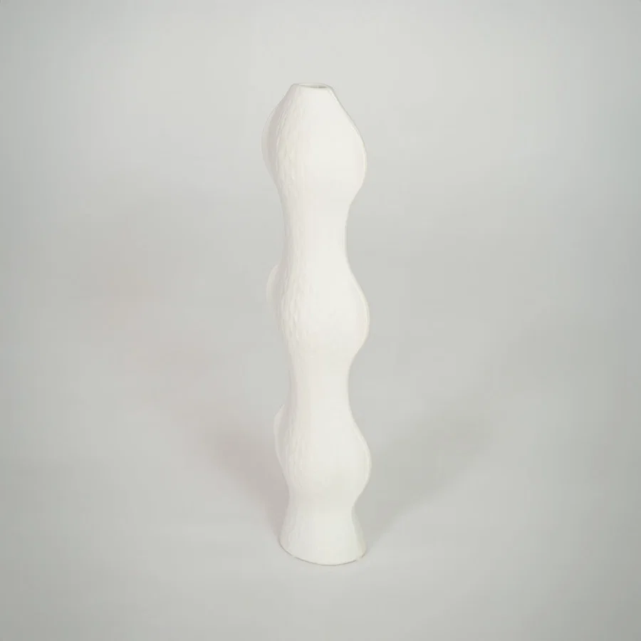 White background image of white ceramic sculptural vase for elegant shelf decor styling with textured finish.