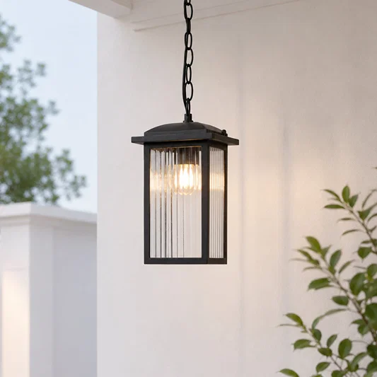 Black metal and glass outdoor hanging lantern for porch entrance balcony and covered patio with warm ambient lighting.