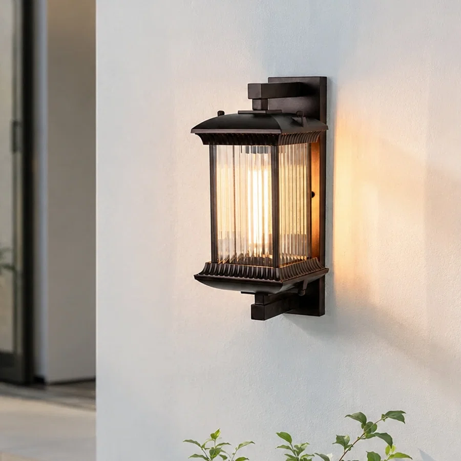 Vintage black metal outdoor hanging lantern for porch entrance balcony and covered patio with warm ambient lighting.