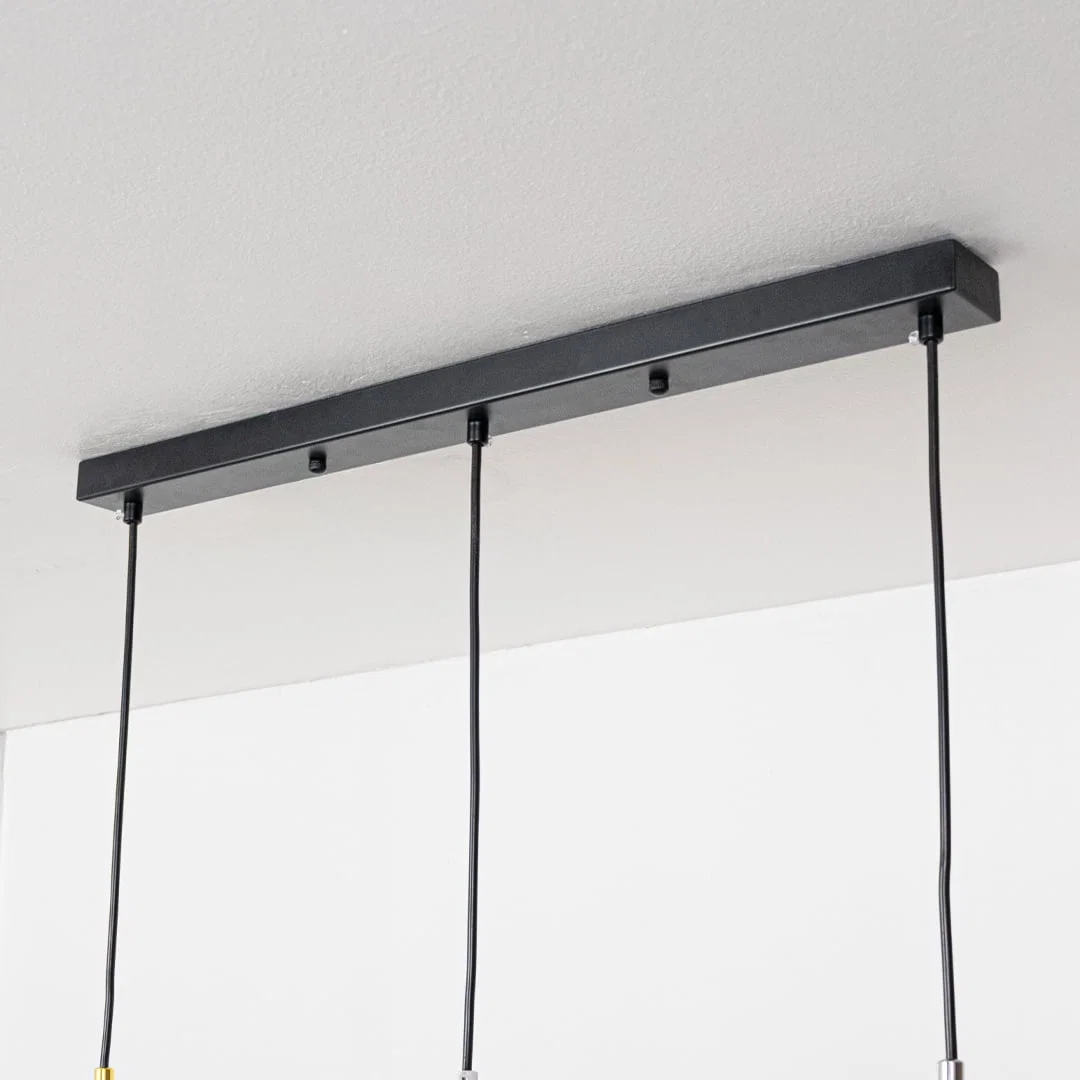 Black metal linear canopy with suspended pendant lights highlighting sleek modern craftsmanship.