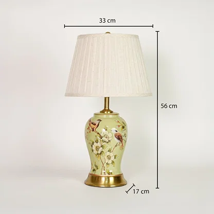 Green ceramic table lamp showing 56 cm height 33 cm shade width and 17 cm base size ideal for bedside placement.