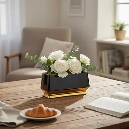 Black and gold metal planter styled on table in modern living room setting for elegant home decor display.