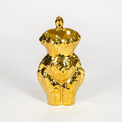 Gold decorative ceramic female sculpture on white background modern home decor accent piece for table shelf console styling.
