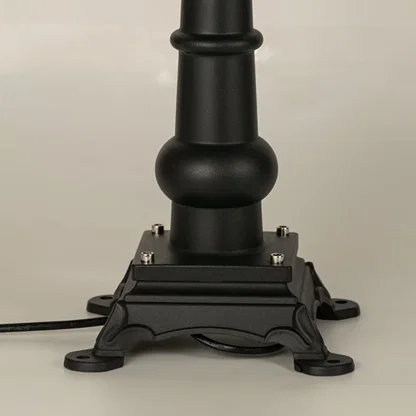 A focused closeup of the lantern top showing the finial structure smooth metal roof and detailed patterned frame that surrounds the frosted glass panel beautifully.