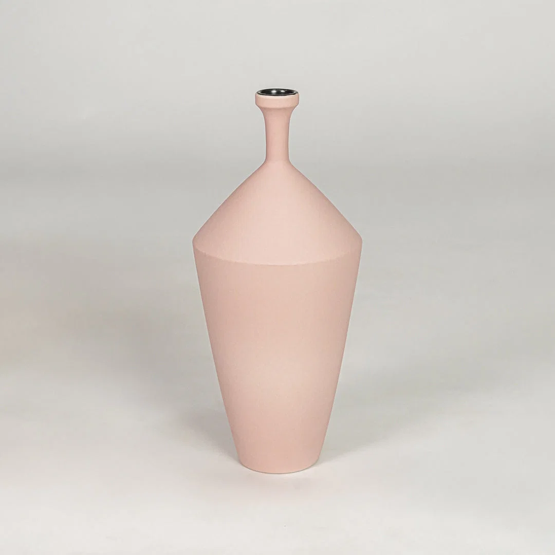Tall slender matte pastel pink vase for chic modern home decor and refined elegant tabletop accent styling needs.