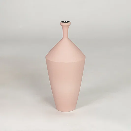 Tall slender matte pastel pink vase for chic modern home decor and refined elegant tabletop accent styling needs.
