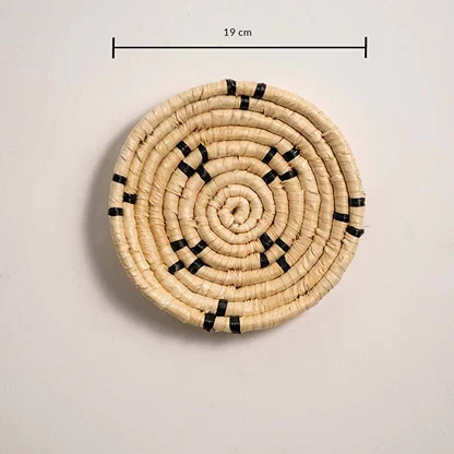 Dimension image of handcrafted natural cream seagrass wall basket with small black block patterns for boho wall decor.