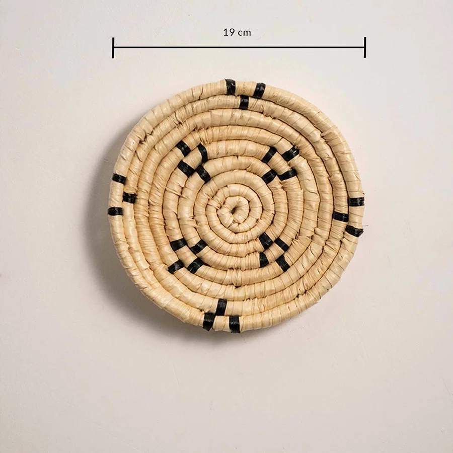 Dimension image of handcrafted natural cream seagrass wall basket with small black block patterns for boho wall decor.