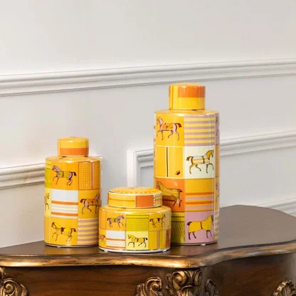 Set of yellow ceramic jars with horse artwork in a front view perfect for bright décor styling and vibrant console display.