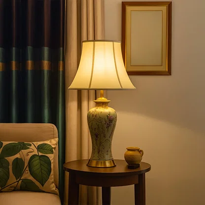 Elegant ceramic table lamp with floral design and golden base styled on side table adding charm to luxury interiors.