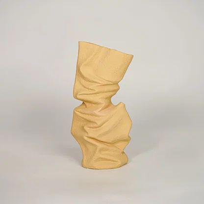 Beige ceramic decorative vase with abstract twisted design for modern console table and shelf decor placement.