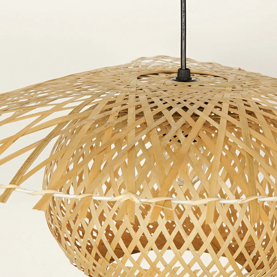 Closeup of handwoven bamboo pendant light with natural finish showcasing intricate craftsmanship.