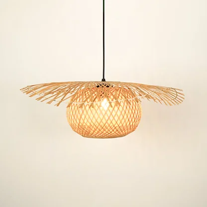 Handwoven rattan pendant light with wide shade illuminated for natural home decor.