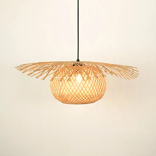 Handwoven rattan pendant light with wide shade illuminated for natural home decor.
