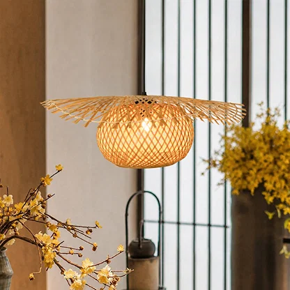 Handwoven rattan pendant light casting warm glow above kitchen island in cozy interiors.