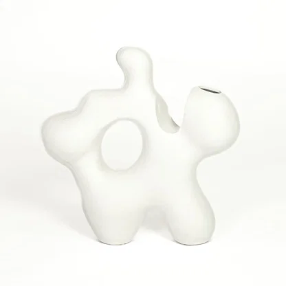 White ceramic abstract decorative sculpture with organic silhouette for contemporary tabletop styling and home decor.