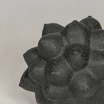 Black ceramic decor sculpture closeup with textured pattern modern showpiece for table console decor styling.