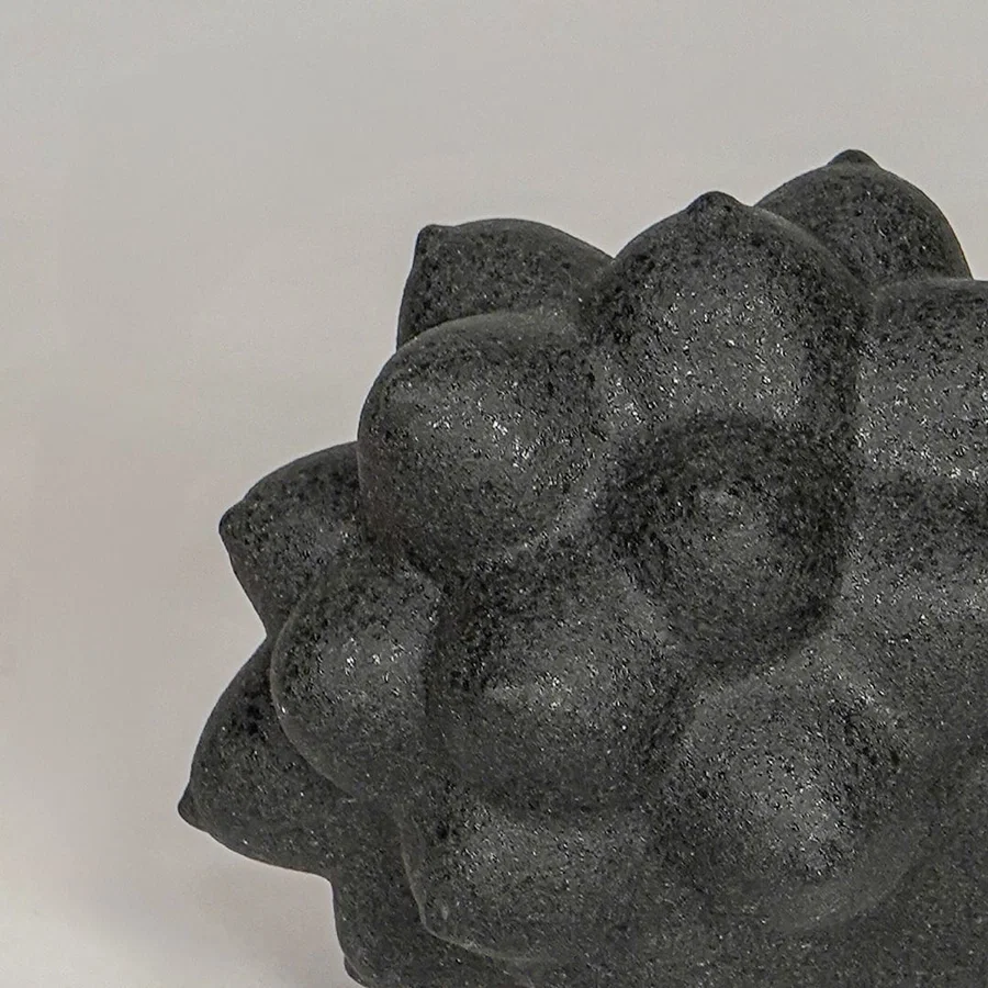 Black ceramic decor sculpture closeup with textured pattern modern showpiece for table console decor styling.