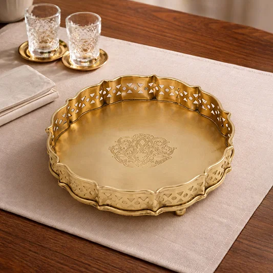 Antique gold metal serving tray placed on a dining table adding luxurious charm and elegant tabletop styling.