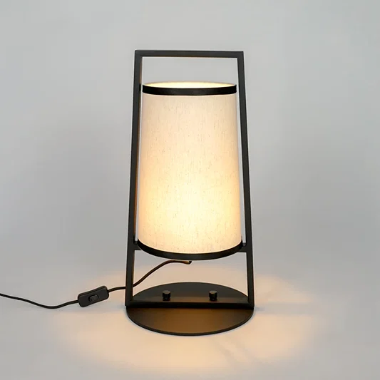 White background image of illuminated metal table lamp for elegant bedroom decor styling and modern home lighting interior.