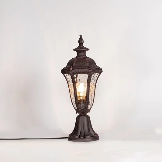Vintage outdoor gate light with black metal frame and warm glass shade for elegant exterior decor use.
