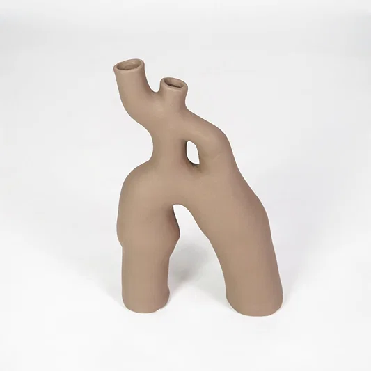 Beige abstract ceramic vase for elegant coffee table placement and modern living room decor styling accent piece.