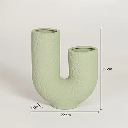 Light green ceramic U shaped vase measuring 25 cm height 22 cm width and 9 cm depth perfect for contemporary home decor styling.