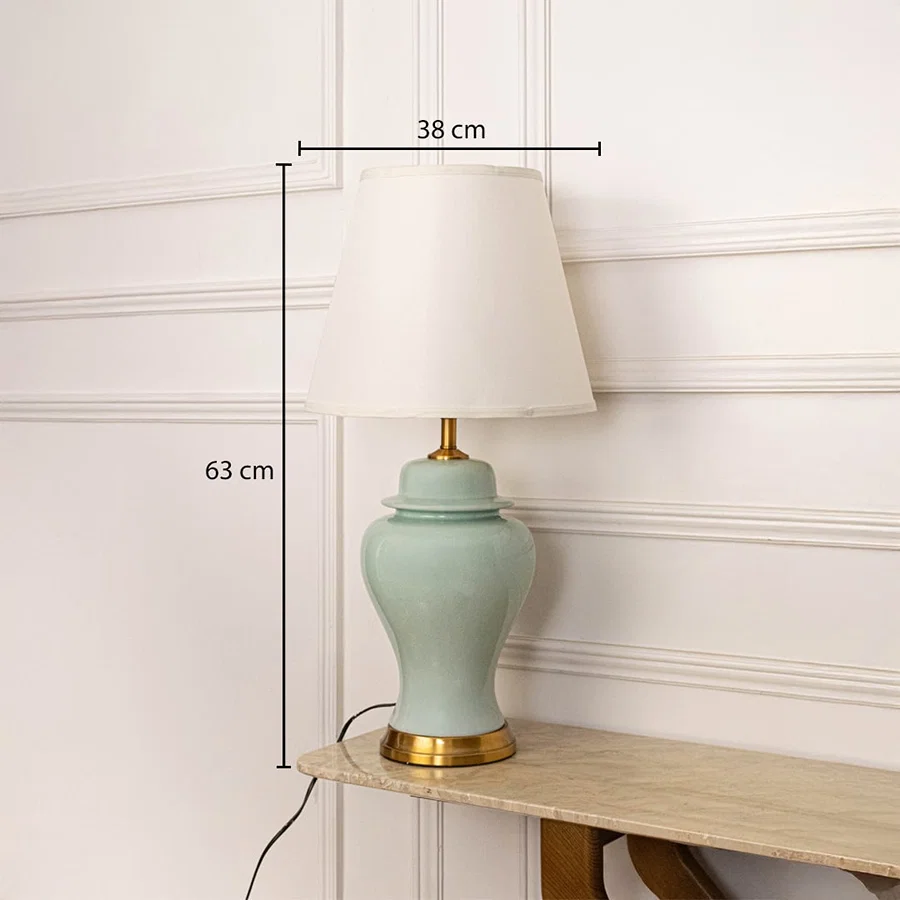 White shade jade green ceramic table lamp with size 63cm height and 38cm width on wooden console table with light off for classic elegant décor.