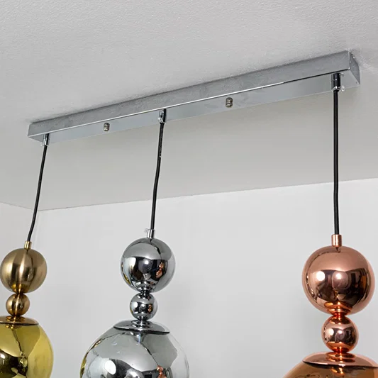 Amber smoke and metallic glass pendant lights showcasing refined modern lighting designs.