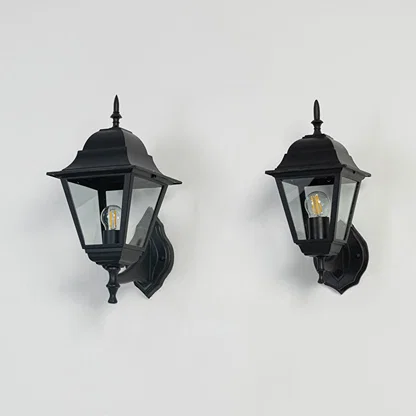 Group of outdoor wall lanterns in black finish displayed off on white background showing detailed glass and metal design.