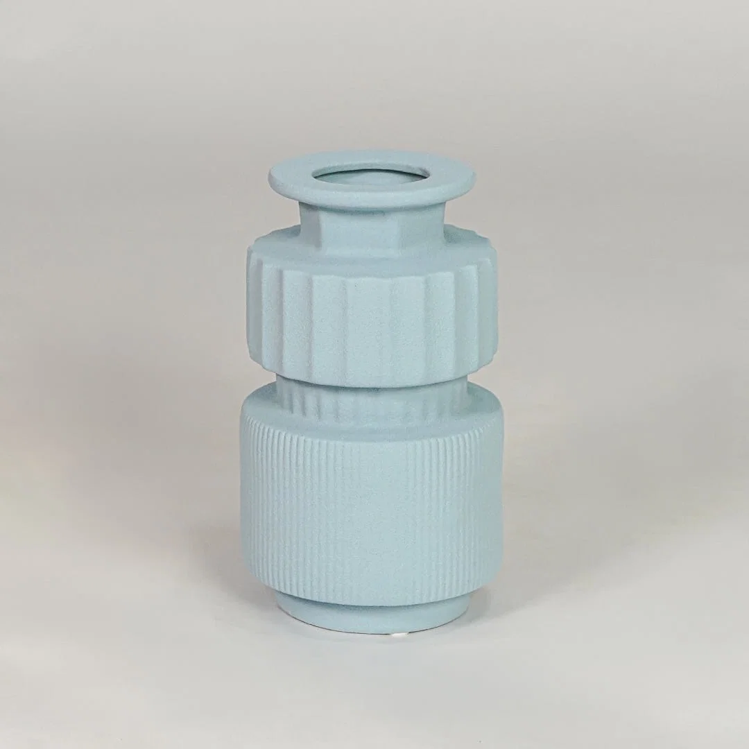 Light blue ceramic decorative vase isolated on white background modern flower vase for living room table decor styling.