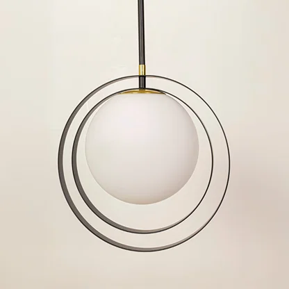 Black and gold metal pendant light closeup highlighting layered circular detailing and premium craftsmanship quality.