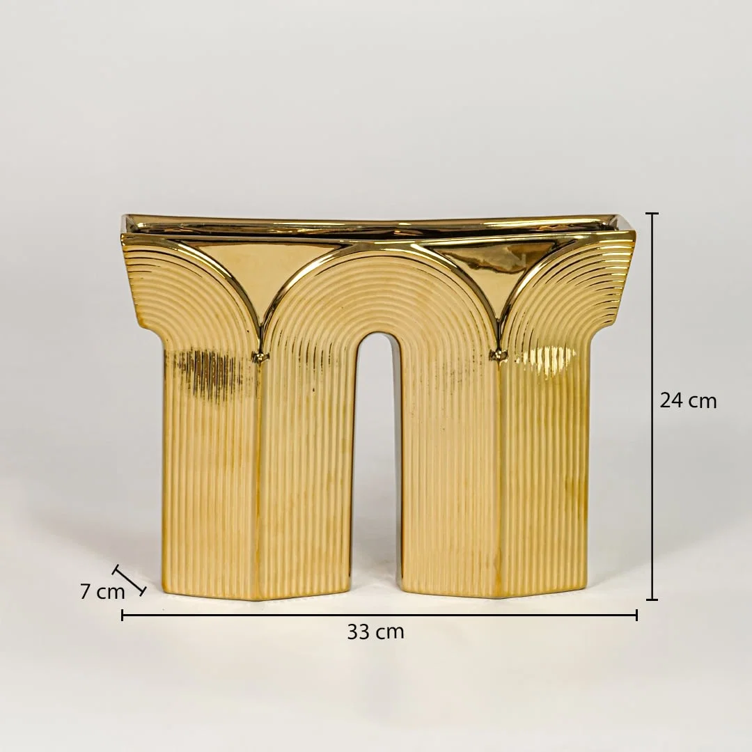 Gold metal decorative sculpture size 24 cm height 33 cm width 7 cm depth modern showpiece for console table styling.