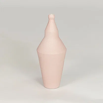 Matte pastel pink tapered sculptural vase for artistic modern home decor and unique interior shelf display style.