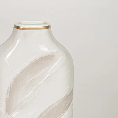 White ceramic decorative vase with elegant beige leaf pattern and gold rim perfect for dried floral display and interior decor.