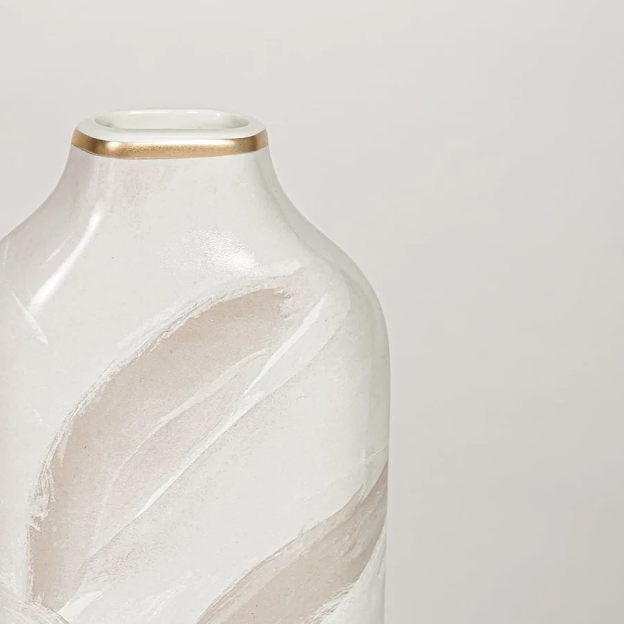 White ceramic decorative vase with elegant beige leaf pattern and gold rim perfect for dried floral display and interior decor.