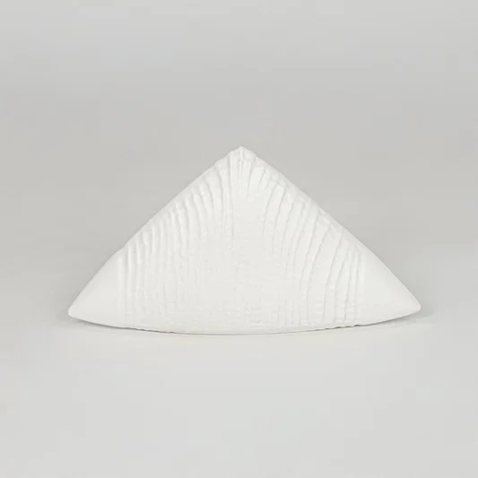 Modern white decorative ceramic showpiece isolated clean background stylish home decor accent piece.