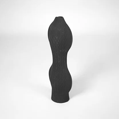 White background image of black ceramic textured vase for modern interior decor styling with matte finish.